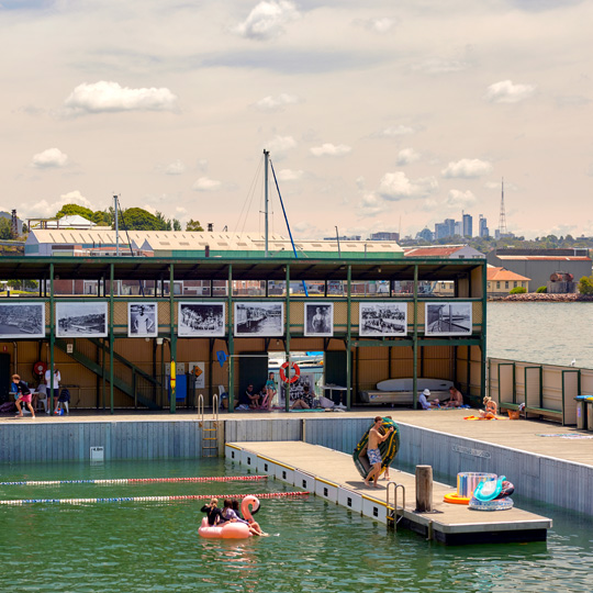 Photo of people in the water and on the pontoon at Dawn Fraser Baths